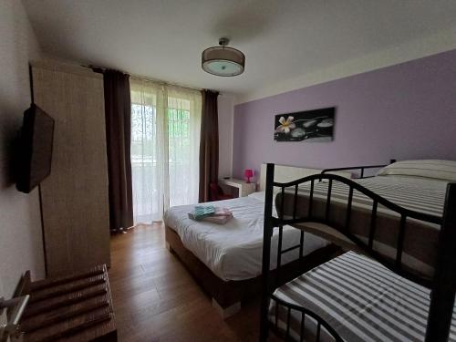 a bedroom with two bunk beds and a window at Bed & go Trento in Trento