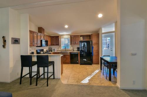 a kitchen with a table and chairs and a refrigerator at Suter's Forte in Wawona