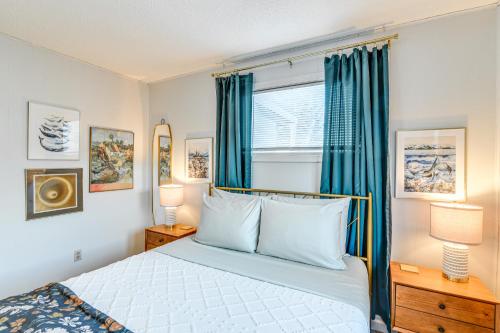 a bedroom with a bed with blue curtains and a window at Close to Downtown and Parks Modern Anchorage Home in Anchorage
