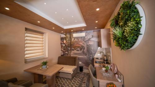 a living room with a table and chairs and a window at SM Exclusive Apartments in Visoko