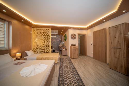 a hotel room with two beds and a bathroom at SM Exclusive Apartments in Visoko