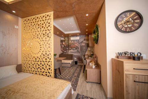 a bedroom with a bed and a clock on the wall at SM Exclusive Apartments in Visoko