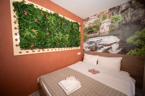 a bedroom with a bed with a flower wall at SM Exclusive Apartments in Visoko