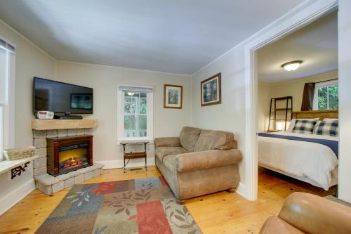 a living room with a couch and a fireplace at Private Fire Pit and Creek Bryson City Retreat! in Bryson City