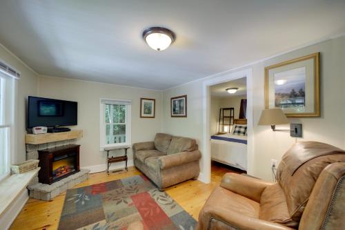 a living room with a couch and a fireplace at Private Fire Pit and Creek Bryson City Retreat! in Bryson City