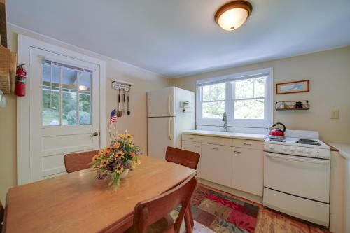 a kitchen with a table and a stove and a sink at Private Fire Pit and Creek Bryson City Retreat! in Bryson City
