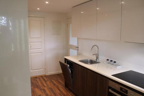a kitchen with a sink and a counter top at New apartment, parking, close to city and nature in Stockholm