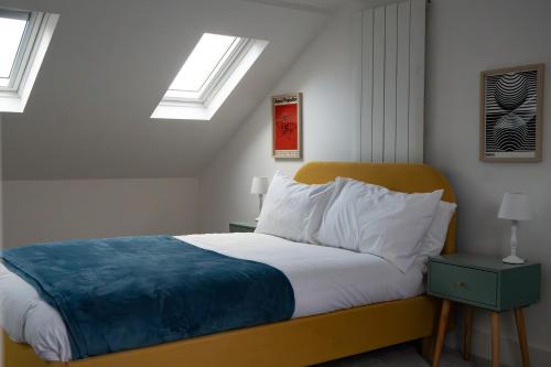 a bedroom with a bed with two skylights at Stylish Brighton Haven, Sleeps 1 to 7, free parking in Brighton & Hove