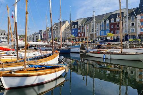 a group of boats docked in a harbor with buildings at Ar vilin in Plouézec