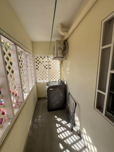 a room with a balcony with a chair and a television at Cozy & Convenient Stay Near Beach, Airport & More! in Koolbaai