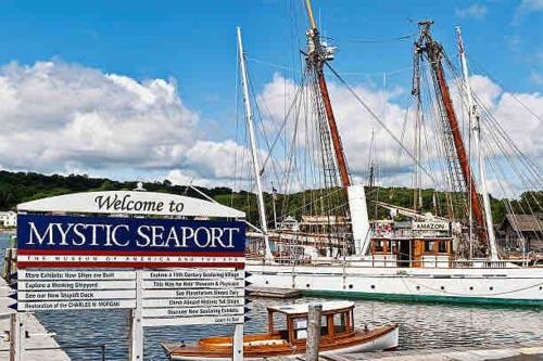 a boat is docked in a marina with a sign at A Luxurious Retreat in Mystic Ct in Groton
