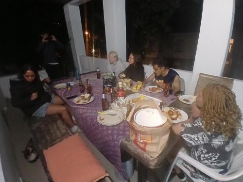 a group of people sitting around a table eating food at TableMountain CityHub in Cape Town