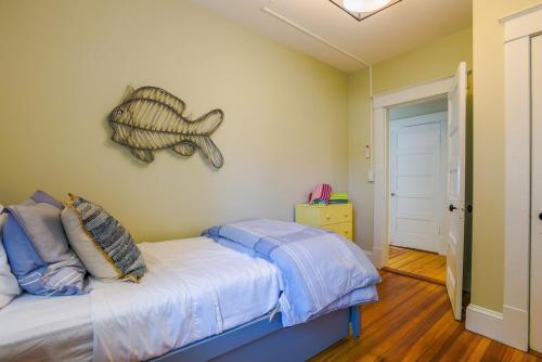 a bedroom with a bed with a fish on the wall at A Luxurious Retreat in Mystic Ct in Groton