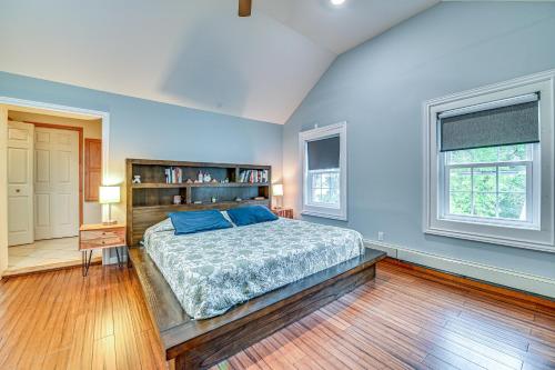 a bedroom with blue walls and a bed and a wooden floor at Charming Ballston Spa Home with Sauna and Private Pool in Ballston Spa