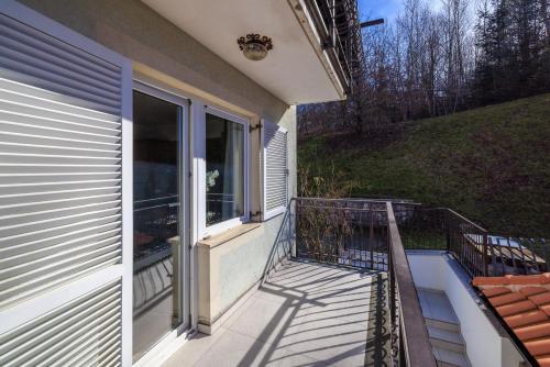 a balcony of a house with a window at Apartments Sofija in Fužine