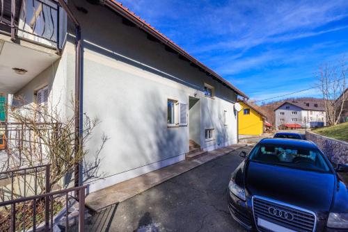 a car parked in a parking lot next to a building at Apartments Sofija in Fužine