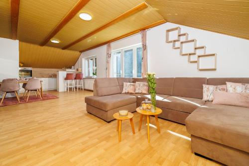 a living room with a couch and a table at Apartments Sofija in Fužine