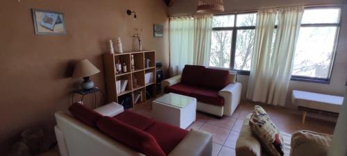 a living room with a couch and a chair at CACHEUTA Casa de Montaña in Ciudad Lujan de Cuyo