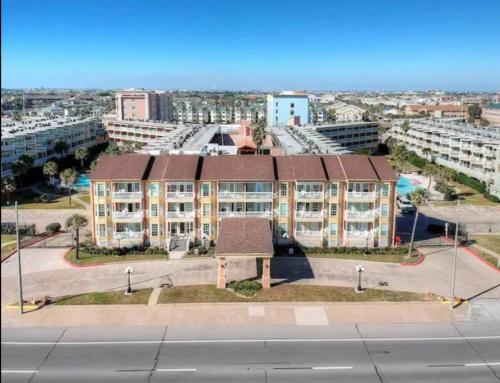 an apartment building in a city with buildings at Ocean & Pool Views on seawall - Shoreline Stays 10 in Galveston