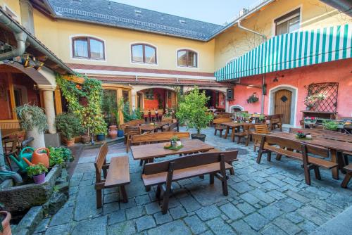 an outdoor patio with wooden tables and benches at Lindengut Natternbach in Natternbach