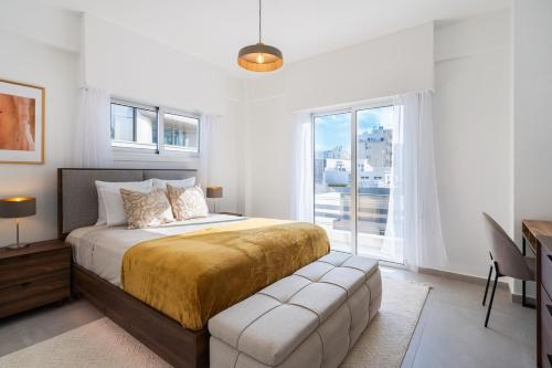 a bedroom with a large bed and a window at Elegant City Central Suite in Nicosia