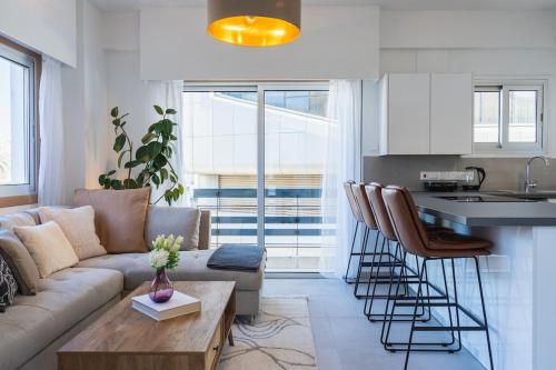a living room with a couch and a kitchen at Elegant City Central Suite in Nicosia