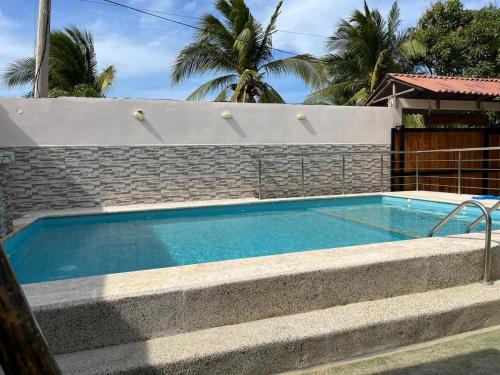 a swimming pool in front of a brick wall at Cabaña Don Jerónimo in Santa Veronica