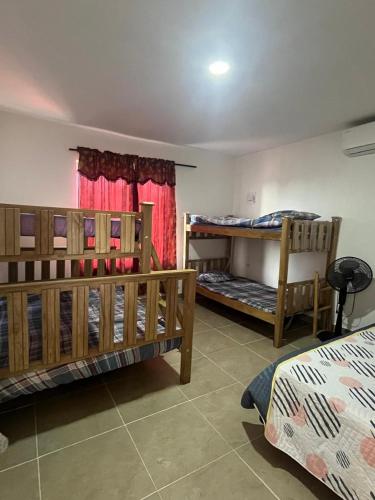 a room with two bunk beds and a window at Cabaña Don Jerónimo in Santa Veronica