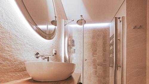 a bathroom with a sink and a shower with a mirror at 2bedroom apartment and condo at Taksim with free parking in Istanbul