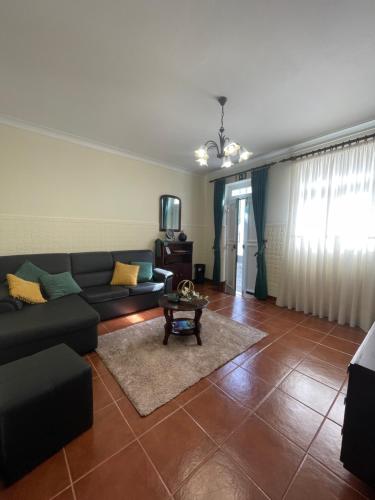 a living room with a couch and a table at Casa São Salvador in Angra do Heroísmo