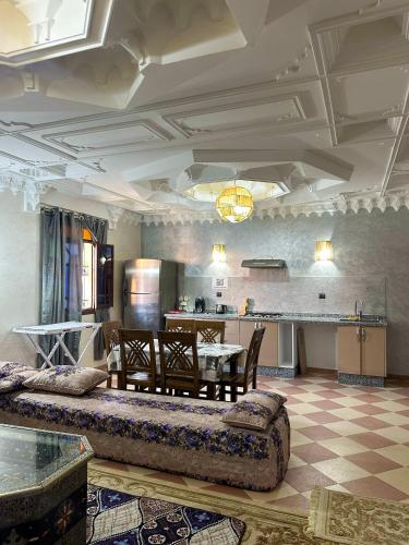 a living room with a table and a kitchen at Moroccan culture Apt! Airport in Marrakech