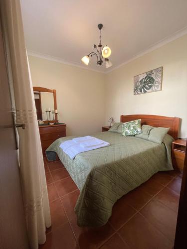 a bedroom with two beds and a mirror in it at Casa São Salvador in Angra do Heroísmo