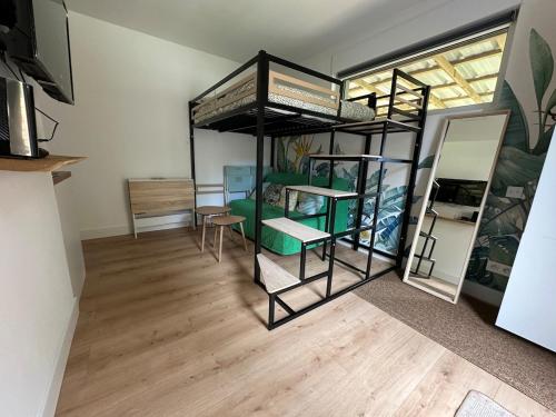 a room with two bunk beds and a table at L'Écrin du Neudorf in Strasbourg