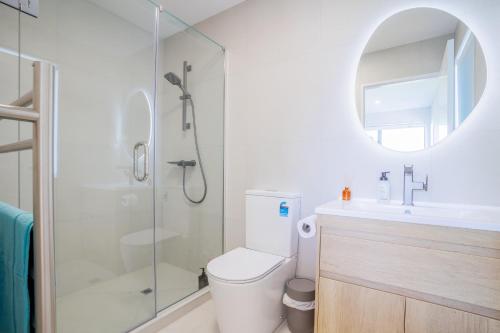 a bathroom with a shower and a toilet and a sink at 4 bedrooms Retreat with Netflix with Prime Location in Auckland