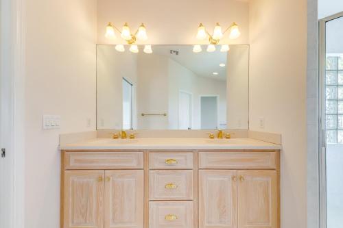 a bathroom with a sink and a large mirror at Half-Mi to Boat Ramp Canal-Front Florida Keys Gem in Tavernier