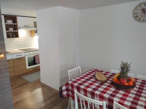 a kitchen with a table with a bowl of fruit on it at Chalupa Borovka in Vitanová