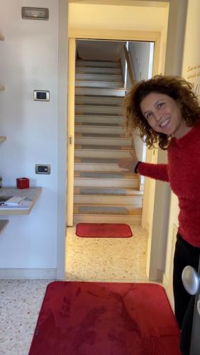 a woman is walking up the stairs at Rosa del Grappa in Rosà