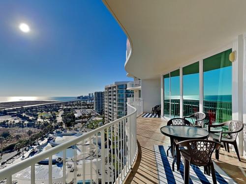 a balcony with tables and chairs and a view of the beach at Caribe The Resort #D1114 in Orange Beach