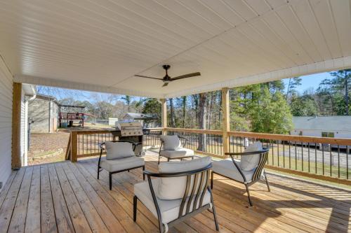 a screened porch with chairs and a ceiling fan at Deck, Grill and Dock Access Lake Keowee Retreat! in Seneca