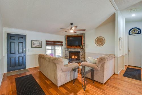 a living room with two couches and a fireplace at Deck, Grill and Dock Access Lake Keowee Retreat! in Seneca