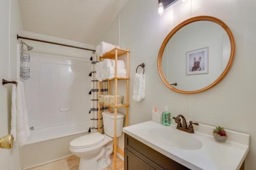 a bathroom with a sink and a toilet and a mirror at Deck, Grill and Dock Access Lake Keowee Retreat! in Seneca