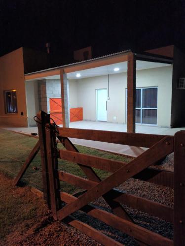 a fence in front of a house at night at Quintas Barceló in Baradero
