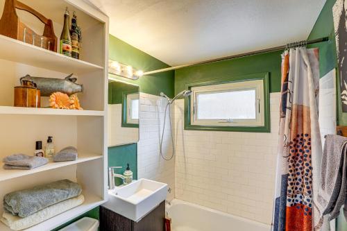 a bathroom with green walls and a sink and a shower at 10 Mi to Red Rocks Denver Home with Fire Pit! in Denver