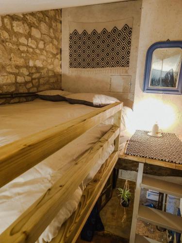 a bedroom with two bunk beds and a table at B&B BienViennue in Marcilly-sur-Vienne