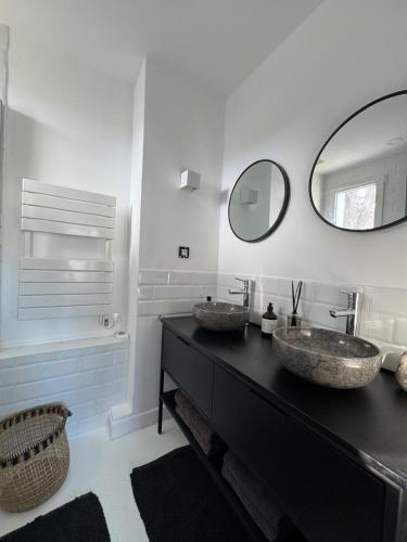 une salle de bain avec deux lavabos et un miroir dans l'établissement Les restanques maison des chênes vue mer 6 personnes, à Grimaud