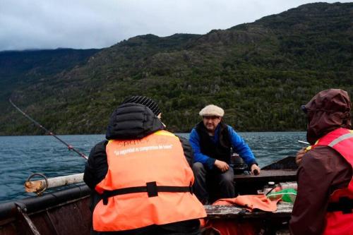 a group of people on a boat in the water at Refugio de Montaña Patagonia, pesca, trekking, miradores in Llanada Grande