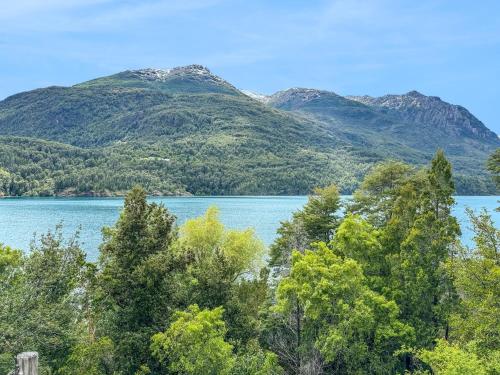 a view of a lake with mountains in the background at Refugio de Montaña Patagonia, pesca, trekking, miradores in Llanada Grande