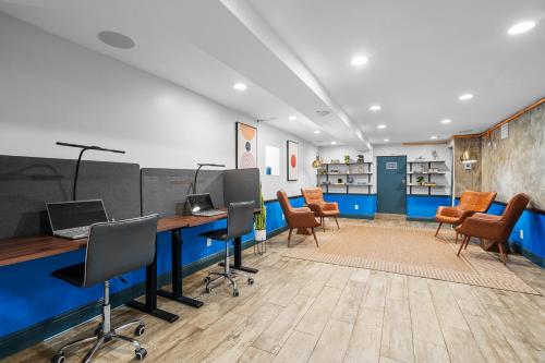 an office with desks and chairs in a room at Nine20 Collins Apartments by Lowkl in Miami Beach