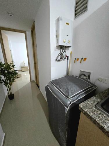 a kitchen with a trashcan in the corner of a room at Cálido y moderno lugar Sabaneta in Sabaneta