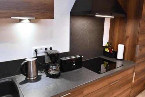 a kitchen with a counter top with a coffee maker at Gîte Entre Vignes et Vergers maison historique in Gueberschwihr